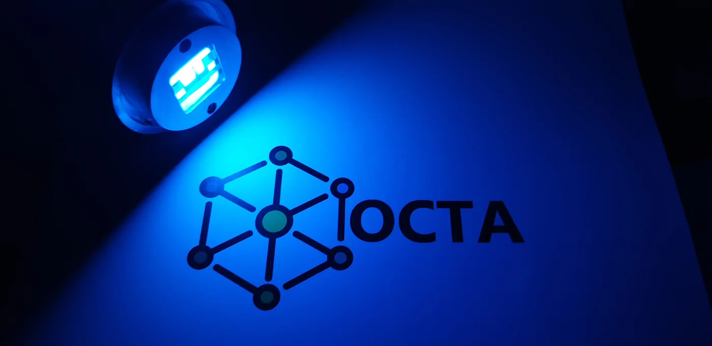 Blue-emitting OLED illuminating the OCTA project logo